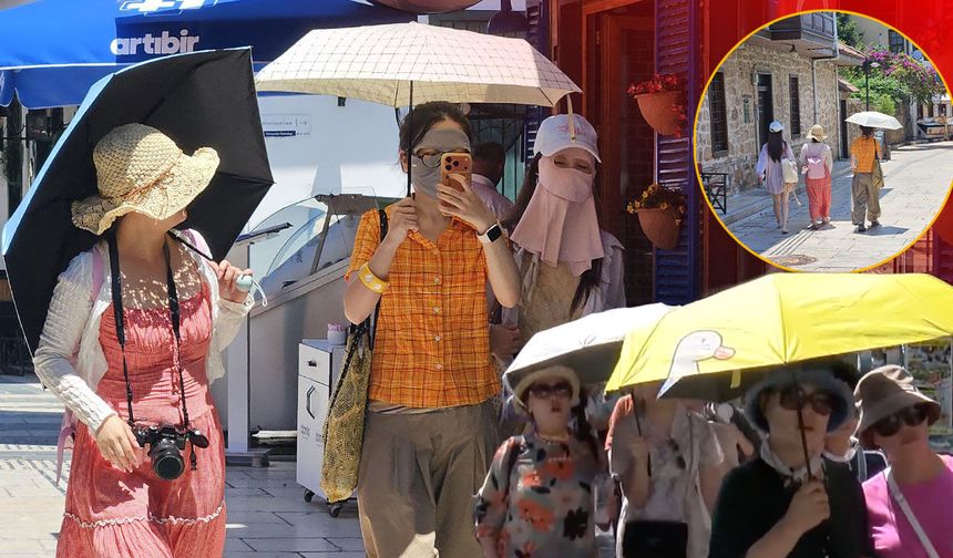 Antalya'da dikkat çeken görüntü: Uzak Doğulu turistler sıcaktan böyle korundu!